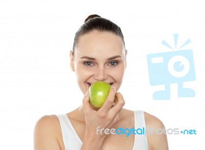 Woman Eating Green Apple Stock Photo