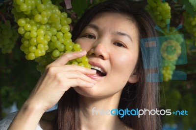 Woman Eating Green Grapes Friut Stock Photo