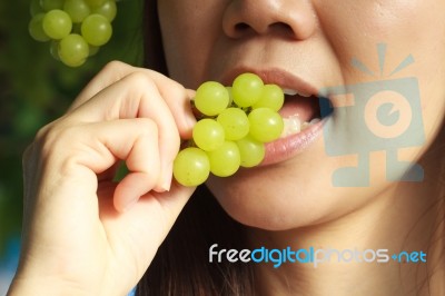 Woman Eating Green Grapes Friut Stock Photo