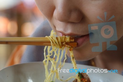 Woman Eating Noodles Stock Photo