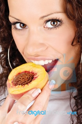 Woman Eating Peach Stock Photo