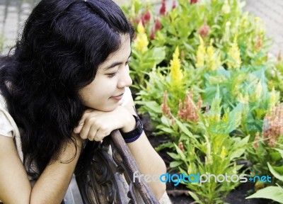 Woman Enjoying Flowers Stock Photo