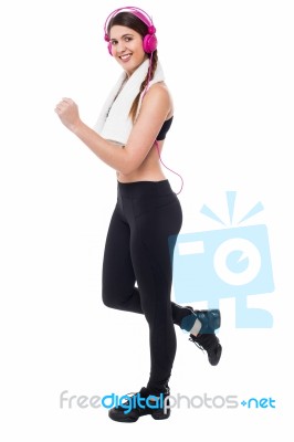 Woman Enjoying Music While Exercising Stock Photo