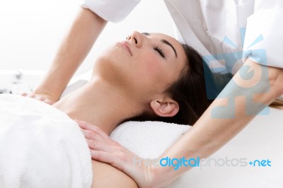 Woman Enjoying Shoulder Massage At Beauty Spa Stock Photo