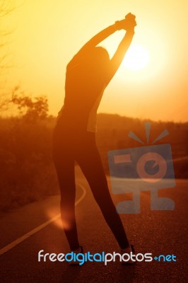 Woman Exercising Outdoor At Sunset  Stock Photo