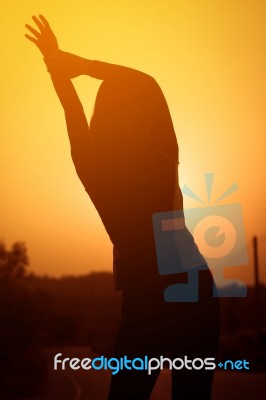 Woman Exercising Outdoor At Sunset  Stock Photo