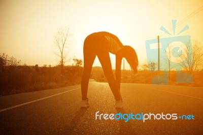 Woman Exercising Outdoor At Sunset  Stock Photo