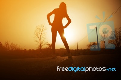 Woman Exercising Outdoor At Sunset  Stock Photo