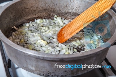 Woman Frying Onions Stock Photo