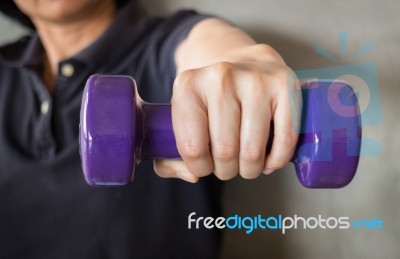 Woman Hand Holding Violet Dumbbell Stock Photo