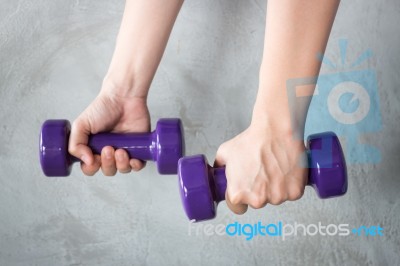 Woman Hand Holding Violet Dumbbell Stock Photo