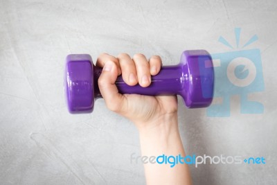 Woman Hand Holding Violet Dumbbell Stock Photo