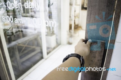 Woman Hand Opening Shop Door Stock Photo