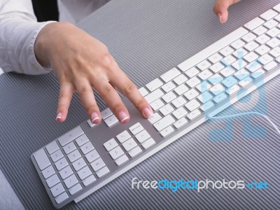 Woman Hand Typing On Keyboard Stock Photo