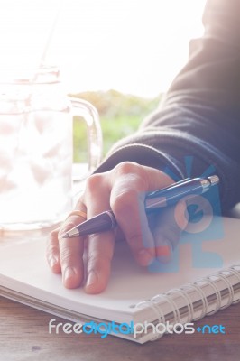 Woman Hand With Pen Writing On Notebook Stock Photo