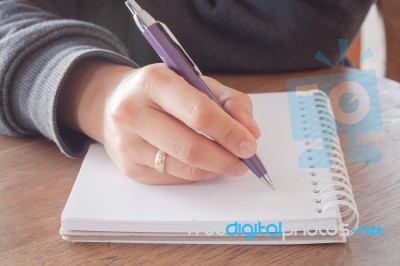 Woman Hand With Pen Writing On Notebook Stock Photo