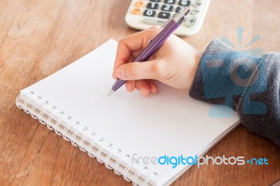 Woman Hand With Pen Writing On Notebook Stock Photo