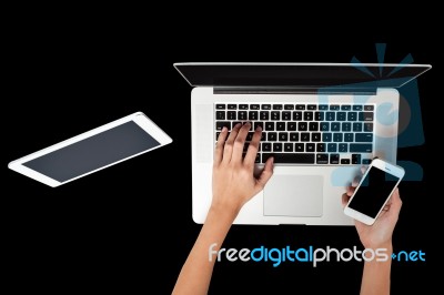 Woman Hand Working On Laptop, Holding A Smartphone Stock Photo