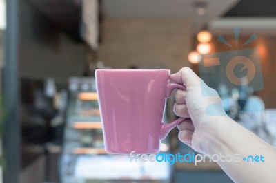 Woman Hands Holding Coffee Cup With Blurred Coffee Shop Stock Photo