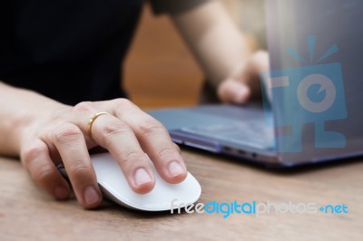 Woman Hands Using Laptop And Wireless Mouse Stock Photo