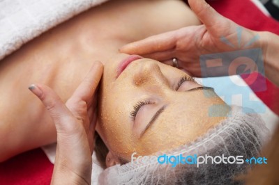 Woman Having Facial Mask At Beauty Salon Stock Photo