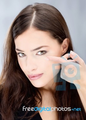 Woman Hold Conctact Lens In Front Of Eye Stock Photo