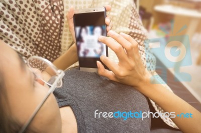 Woman Holding And Using Smartphone At Room Stock Photo