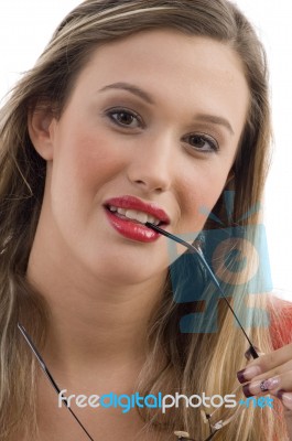 Woman Holding Eyeglasses Stock Photo