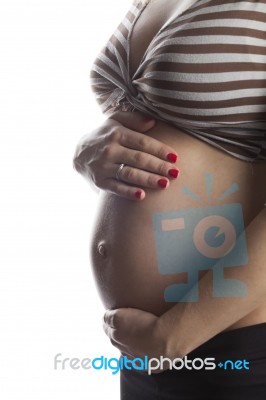 Woman Holding Her Pregnant Belly. White Background Stock Photo