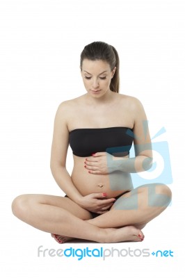 Woman Holding Her Pregnant Belly. White Background Stock Photo