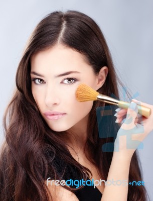 Woman Holding Powder Brush Stock Photo