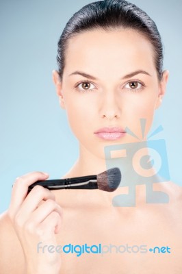 Woman Holding Powder Brush Stock Photo