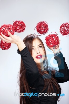 Woman Holding Red Balls Stock Photo