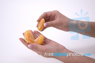 Woman Holding Slices Of Mandarin Stock Photo