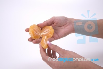 Woman Holding Slices Of Mandarin Stock Photo