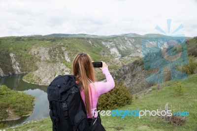 Woman Holding Smartphone Against Mountain Background. Ecology Concept Stock Photo