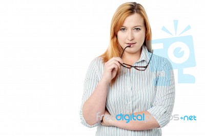 Woman Holding Spectacles And Thinking Stock Photo