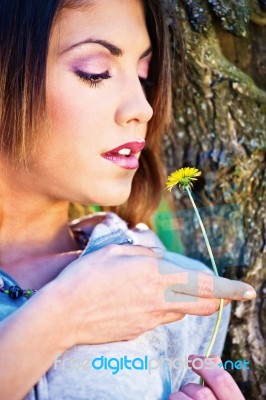 Woman Holding Yellow Flower Stock Photo