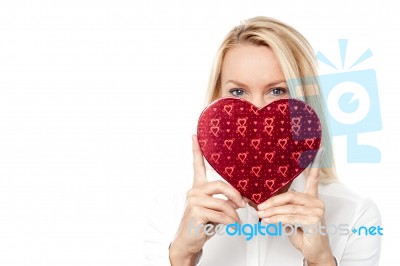 Woman Holds A Heart Shape To Her Face Stock Photo