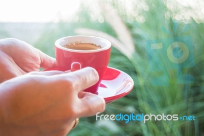 Woman Holds A Red Coffee Cup (vintage Style Color) Stock Photo