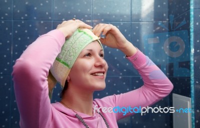 Woman In A Bathroom With A Towel On Her Head Stock Photo