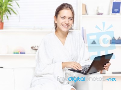 Woman In Bathrobe With Computer Stock Photo