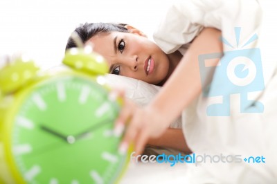 Woman In Bed With Alarm Clock Stock Photo