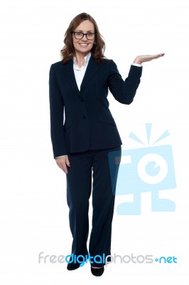 Woman In Business Attire Posing With An Open Palm Stock Photo