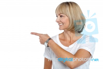 Woman In Casuals Pointing Sideways Stock Photo