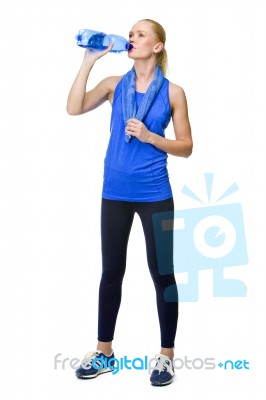 Woman In Fitness Clothing Drinking Stock Photo