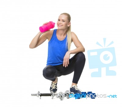 Woman In Fitness Clothing Drinking Stock Photo