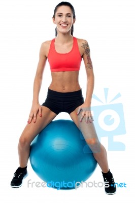 Woman In Gym Relaxing On Pilates Ball Stock Photo