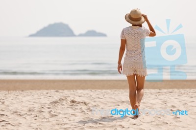 Woman In Hat On Beach Stock Photo