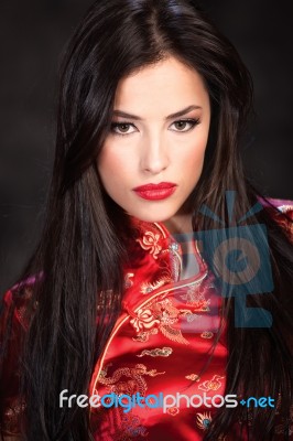 Woman In Red Cheongsam Stock Photo